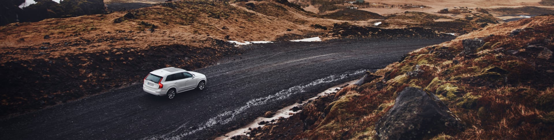 Volvo XC90 driving on a gravel road