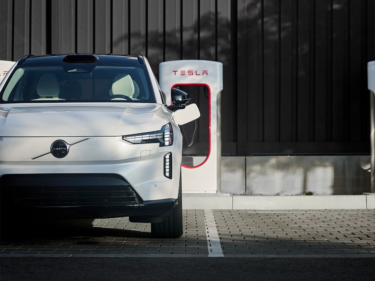 Electric Volvo vehicle charging at a Tesla Supercharger