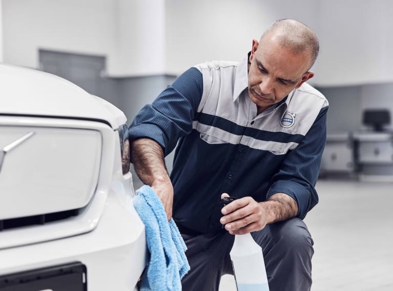 Volvo technician wiping a bumper