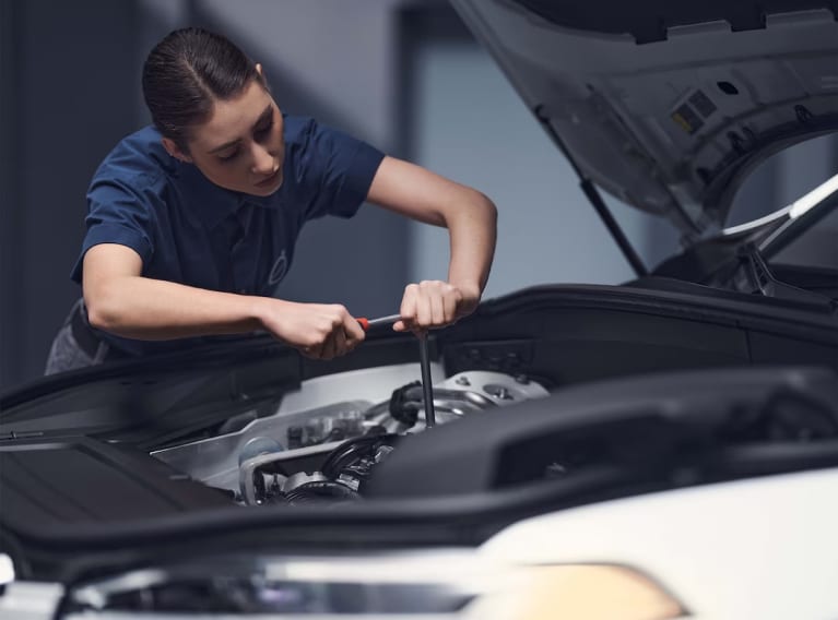 Volvo technician changing engine oil