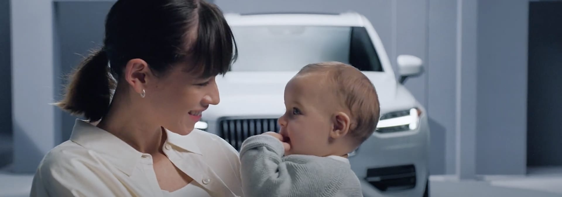 mother and baby in front of a Volvo