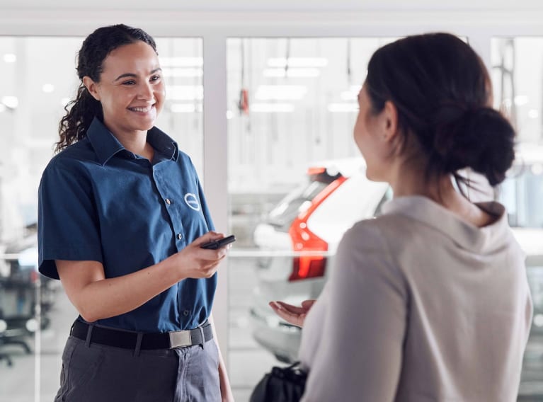 Volvo dealer talking with an owner
