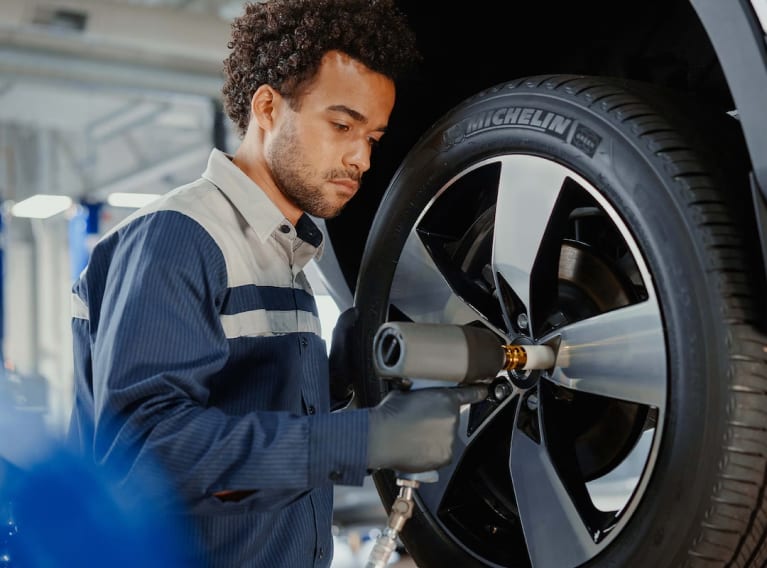 Volvo technician mounting a wheel