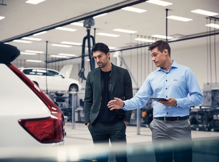 Volvo technician discussing repairs with a customer