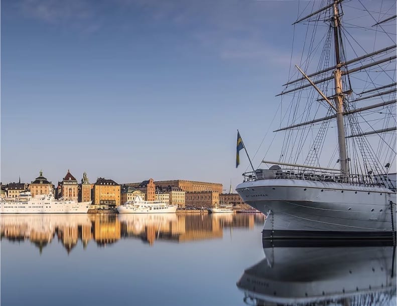 masted ship in a calm Swedish harbor
